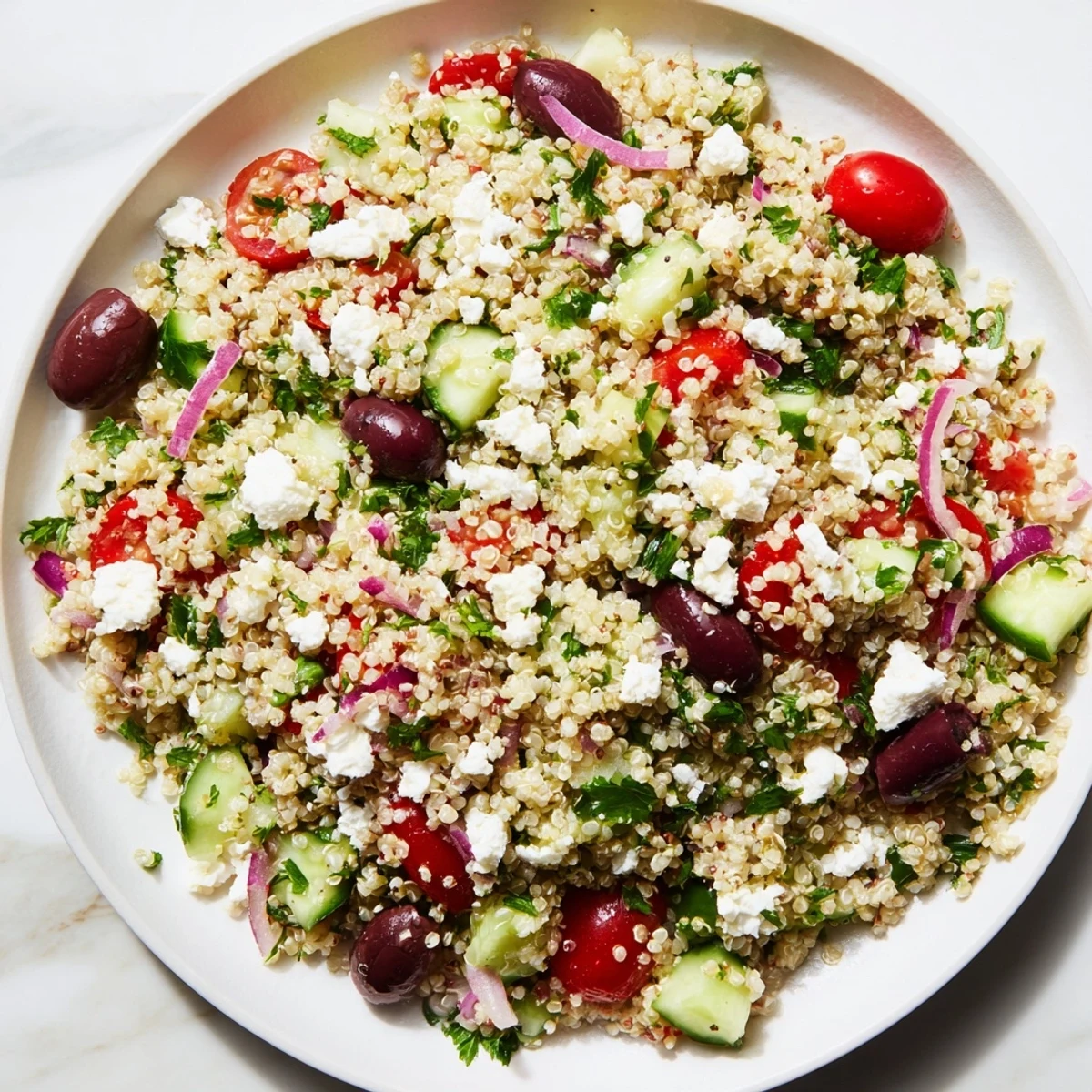 Delectable Mediterranean Quinoa Salad with cucumber, bursting with fresh veggies and tangy feta cheese.