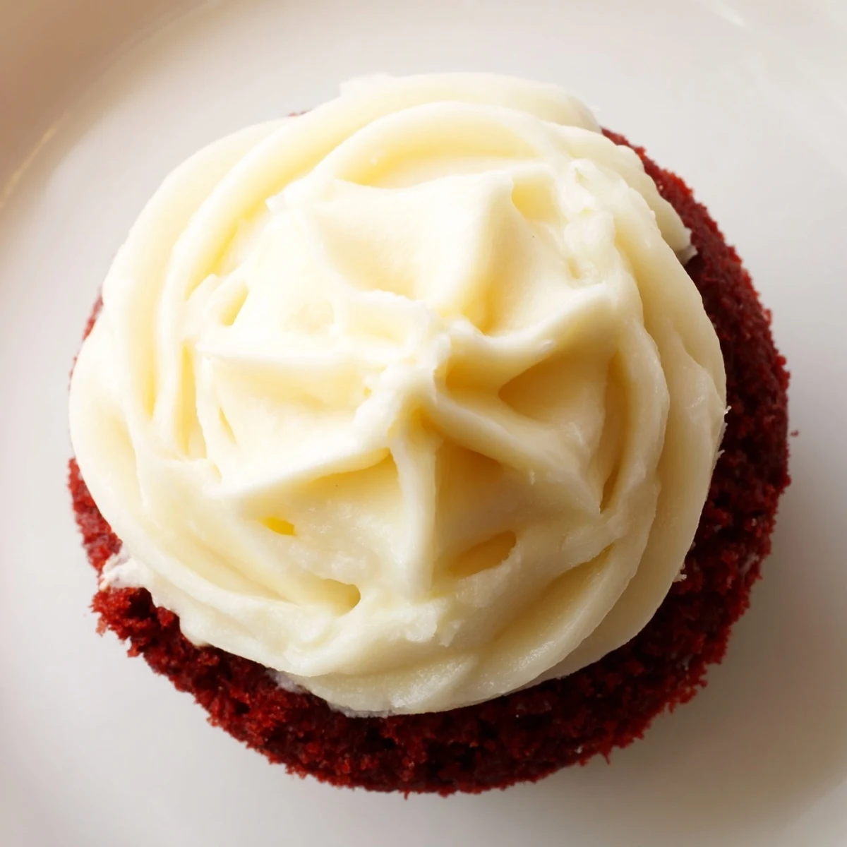 Fluffy red velvet cupcakes with creamy cream cheese frosting, perfect for dessert enjoyment.