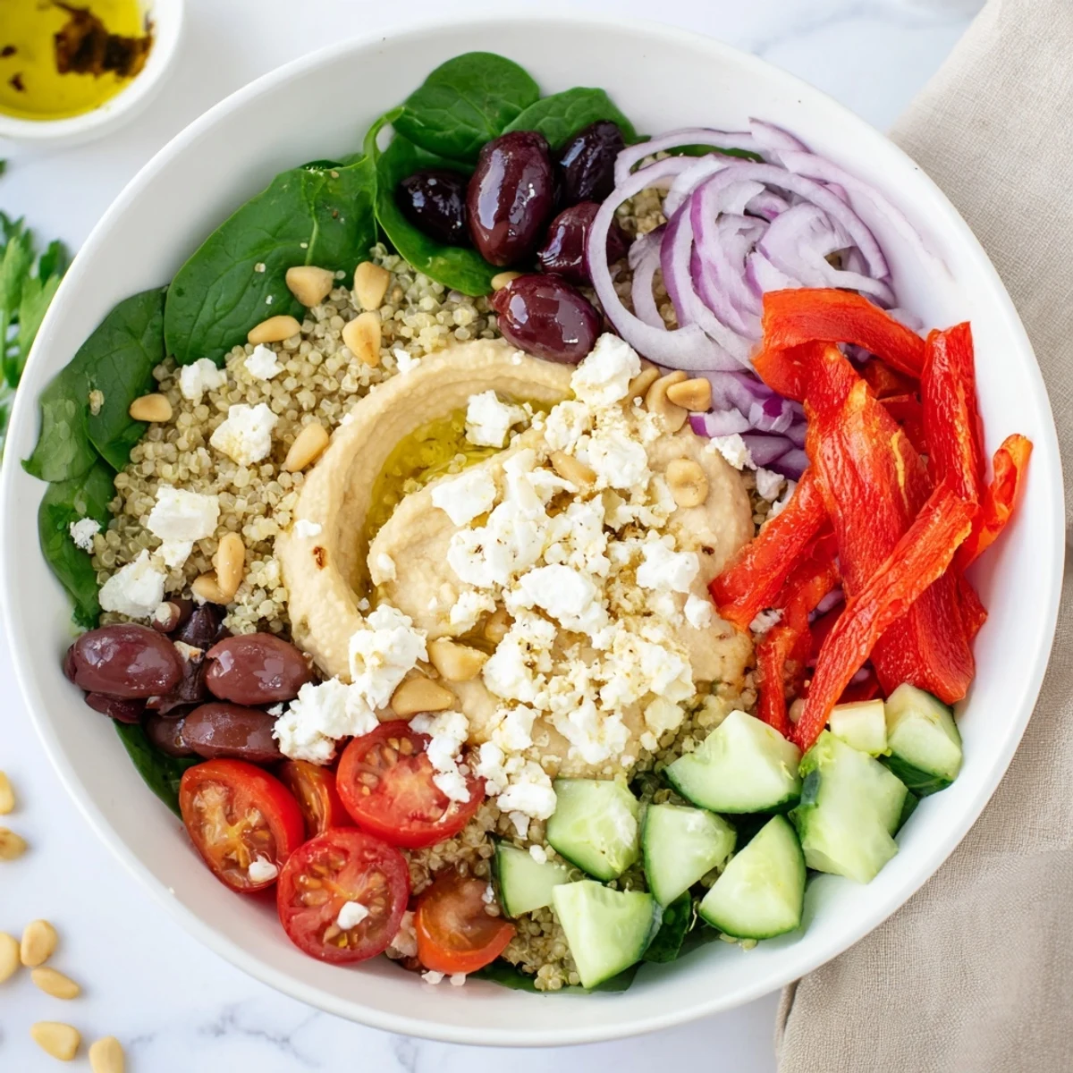 A vibrant Mediterranean Hummus Bowl with chickpeas, crunchy veggies, and tangy feta ready to eat. 