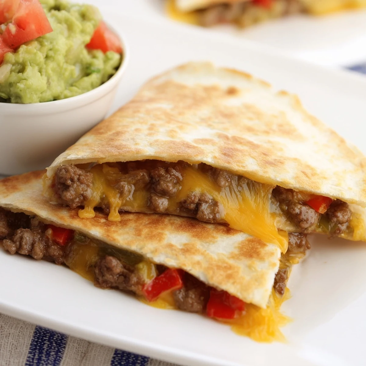 Close-up of sizzling Beef Quesadillas with Guacamole and Salsa, highlighting seasoned meat and melted cheese filling.