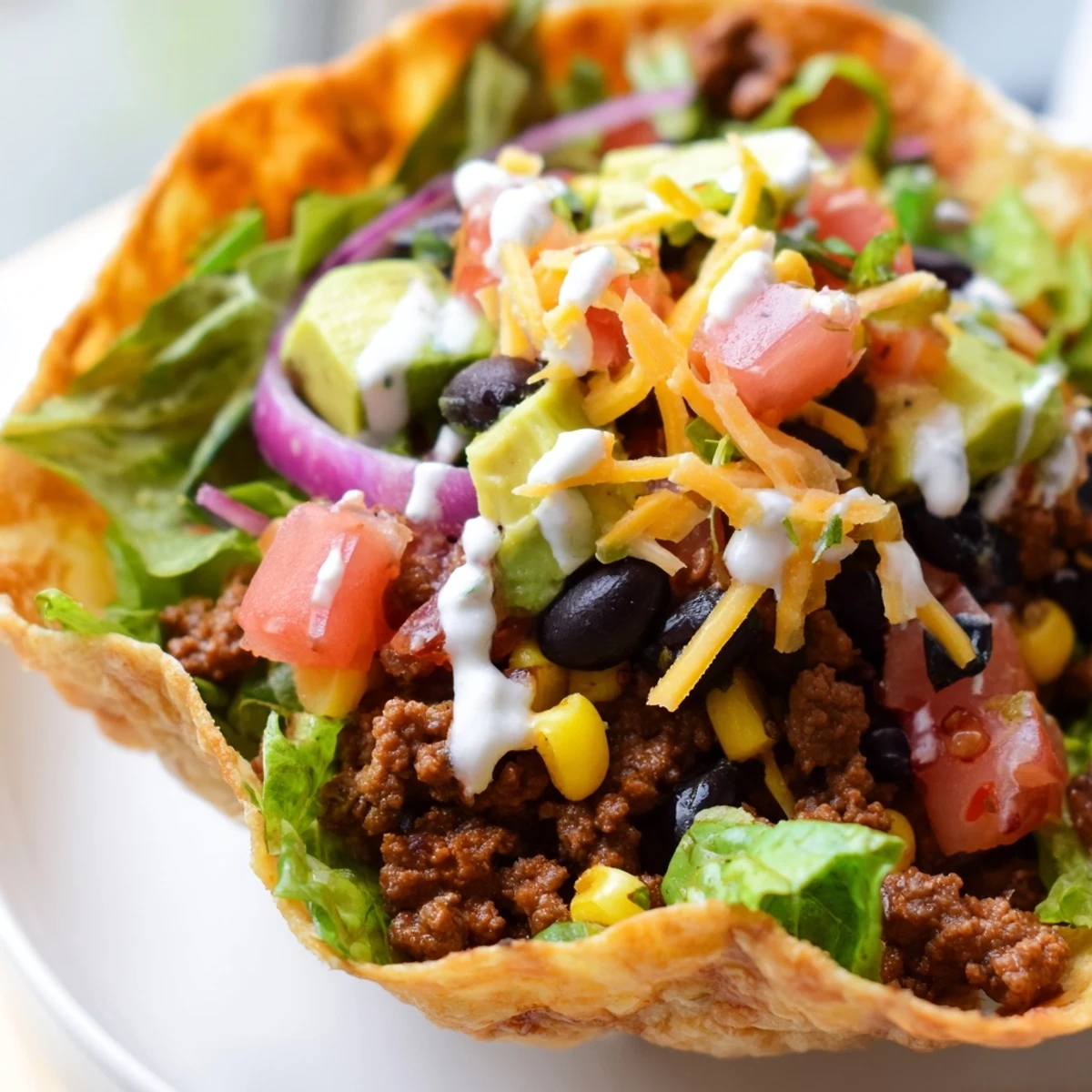 A crunchy baked flour tortilla bowl cradles the spicy beef, corn, and cheese, perfect for a satisfying weeknight meal.