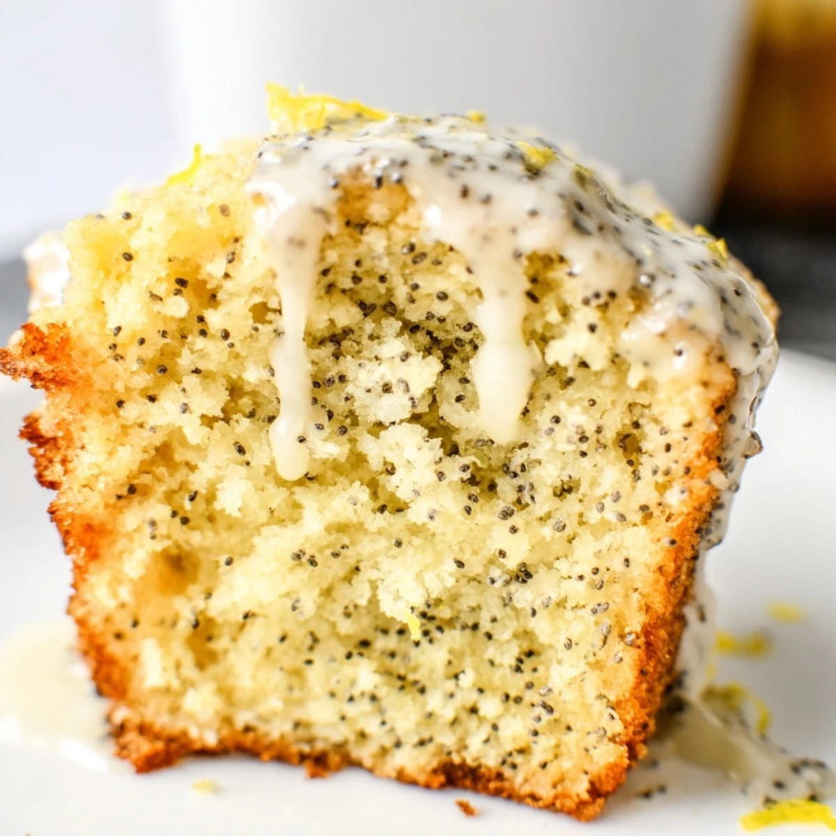 Golden Lemon Poppy Seed Muffins topped with glossy lemon glaze sit on a rustic wooden board, perfect for a bright breakfast or afternoon treat.