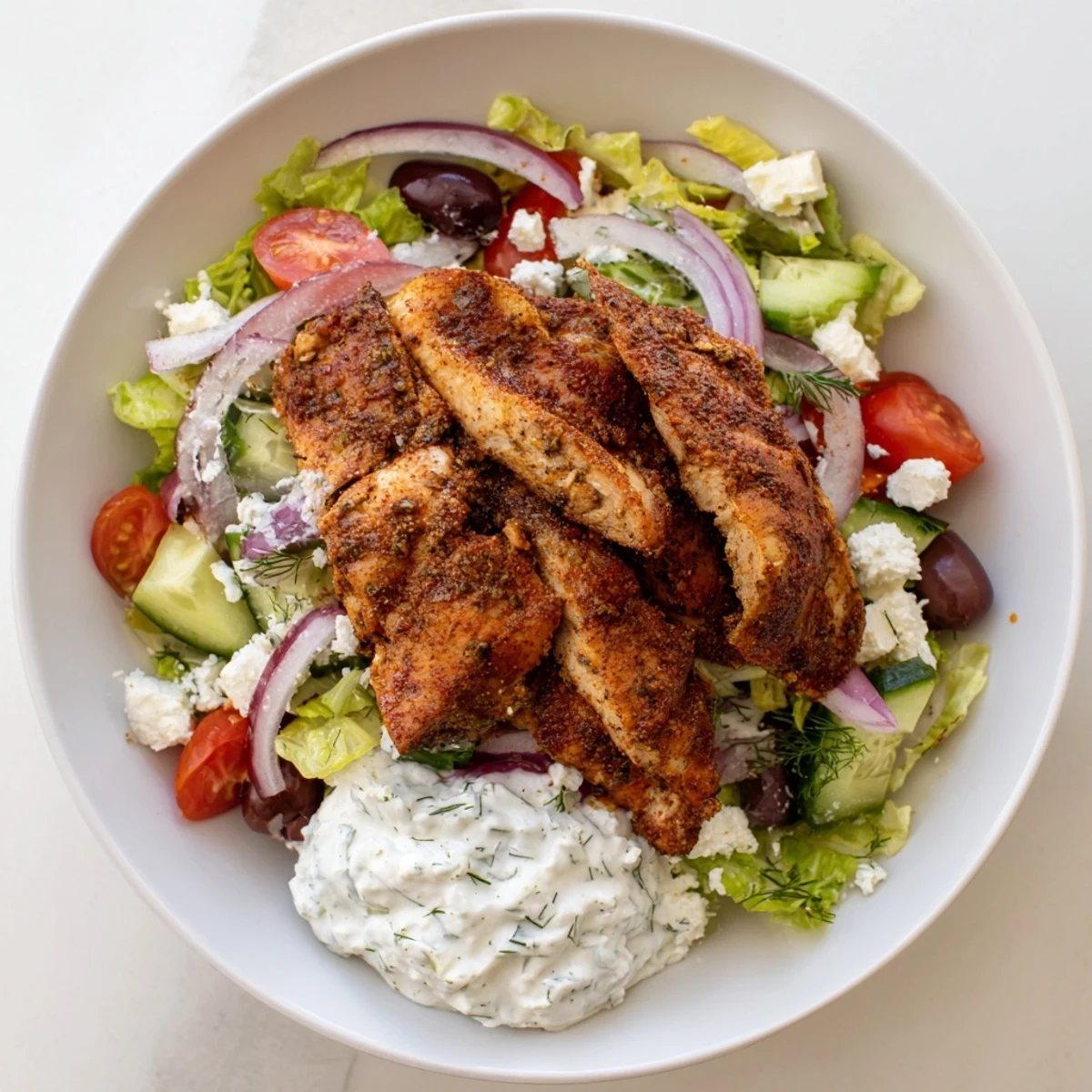 Bright lemon and oregano chicken, crunchy cucumber and tomato, with a generous dollop of tzatziki on fluffy rice.