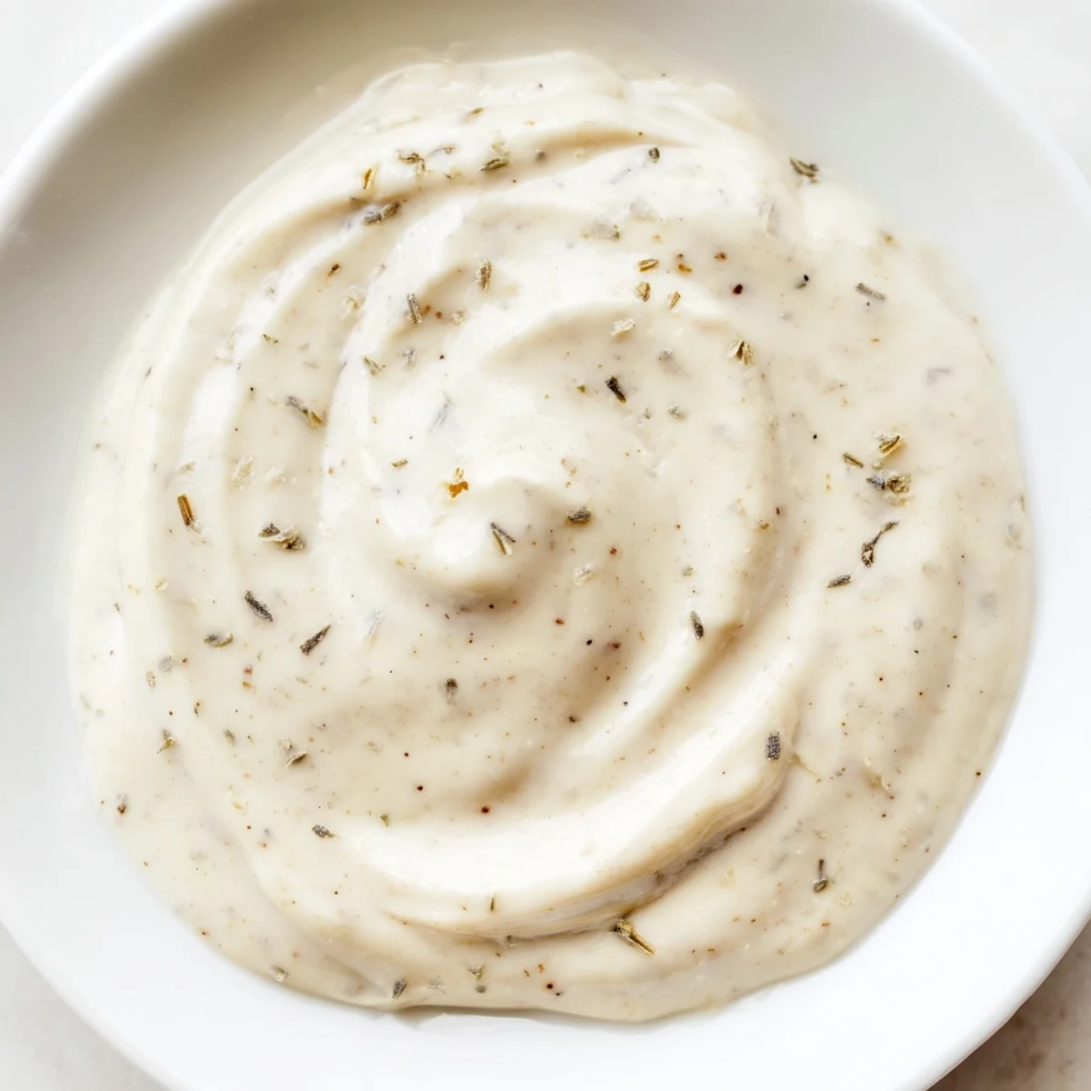 Freshly prepared Hot Honey Ranch Crispy Chicken Tenders Sauce with herbs and a drizzle of honey.