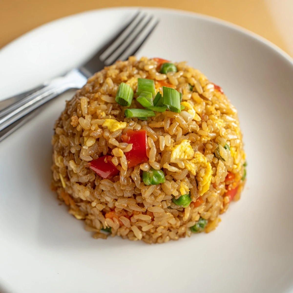 Savory Fried Rice in a skillet with scrambled eggs, diced bell pepper, and a drizzle of soy sauce.