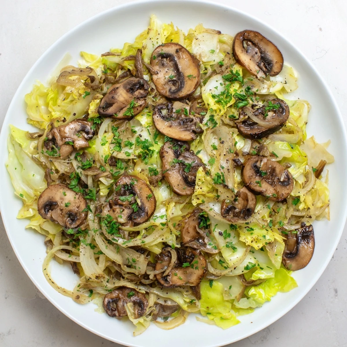Healthy Vegetarian Cabbage Mushroom Sauté served as a side dish with crusty bread.