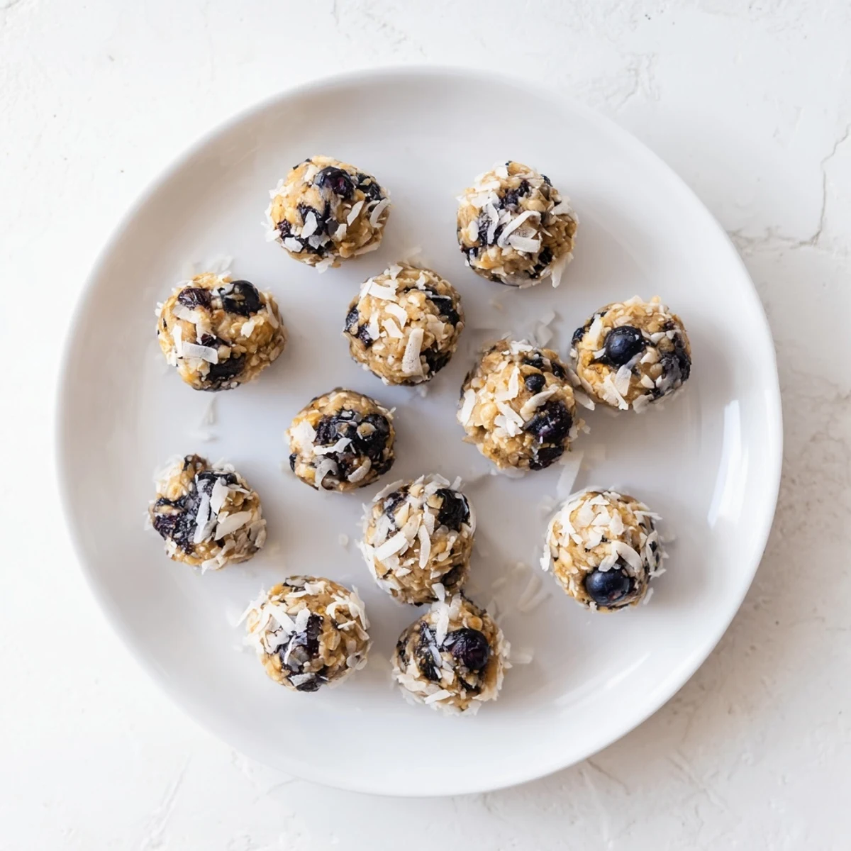 Vibrant Lemon Blueberry Cottage Cheese Protein Bites arranged neatly in a clear glass jar.