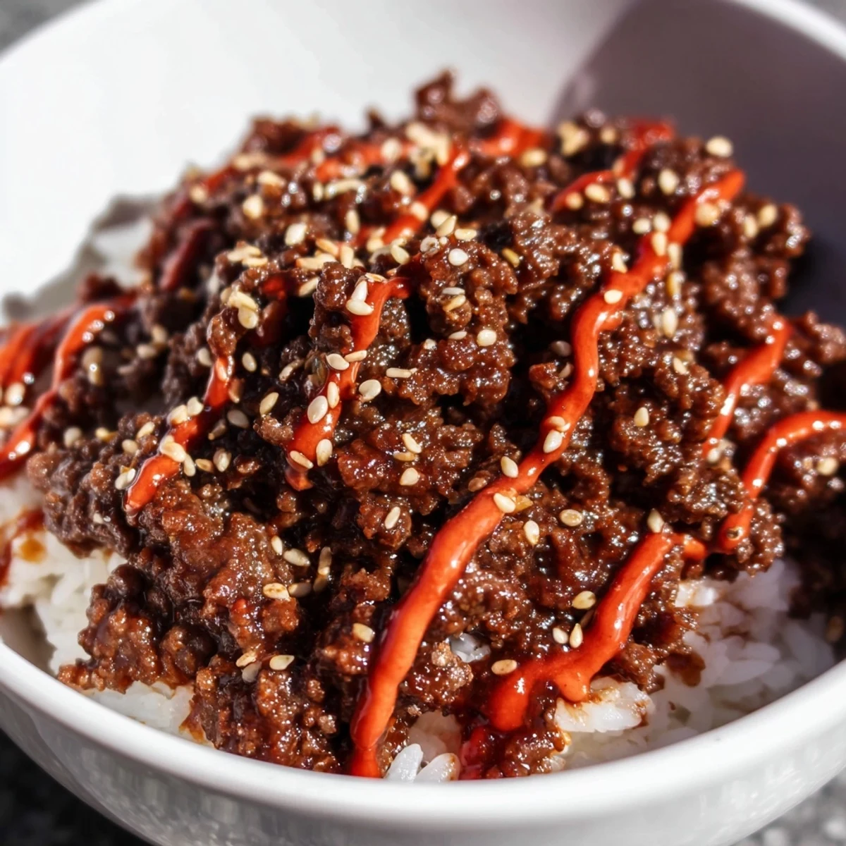 A colorful Korean Beef Bowl with Spicy Mayo features tender beef, fluffy rice, crisp veggies, and creamy drizzle.