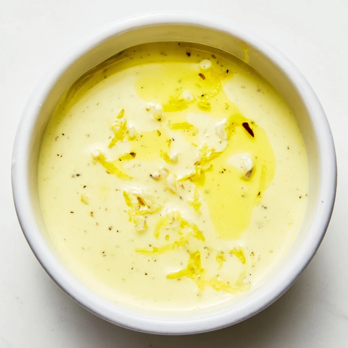 Whisked creamy lemon vinaigrette with olive oil emulsion perfect for fresh garden salads
