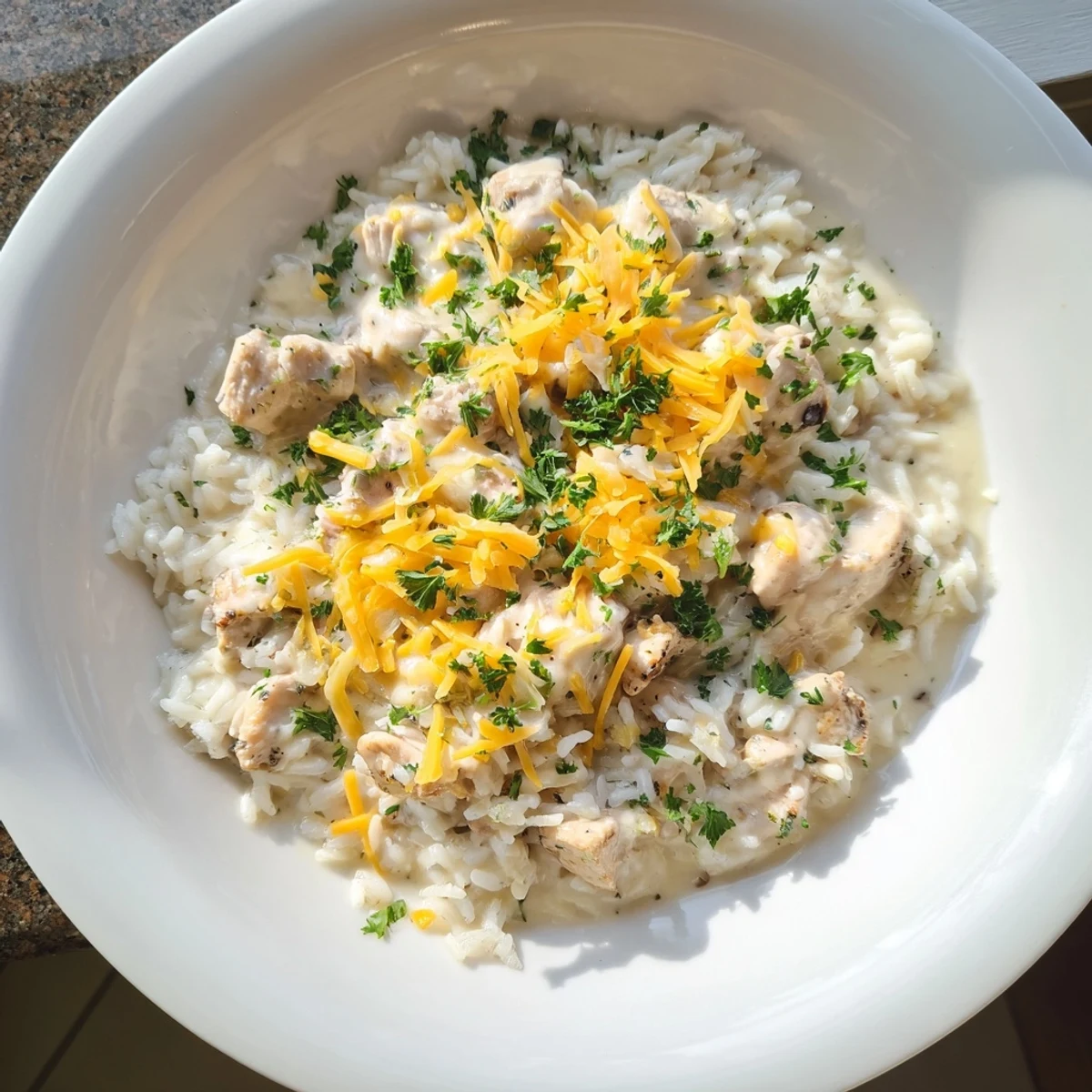 Comforting one-pan creamy smothered chicken and rice with melted cheddar topping