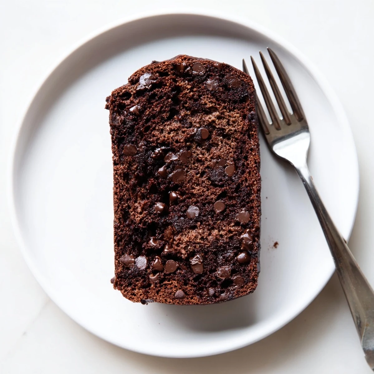 Sliced chocolate espresso banana bread revealing dark chocolate chunks and tender crumb texture