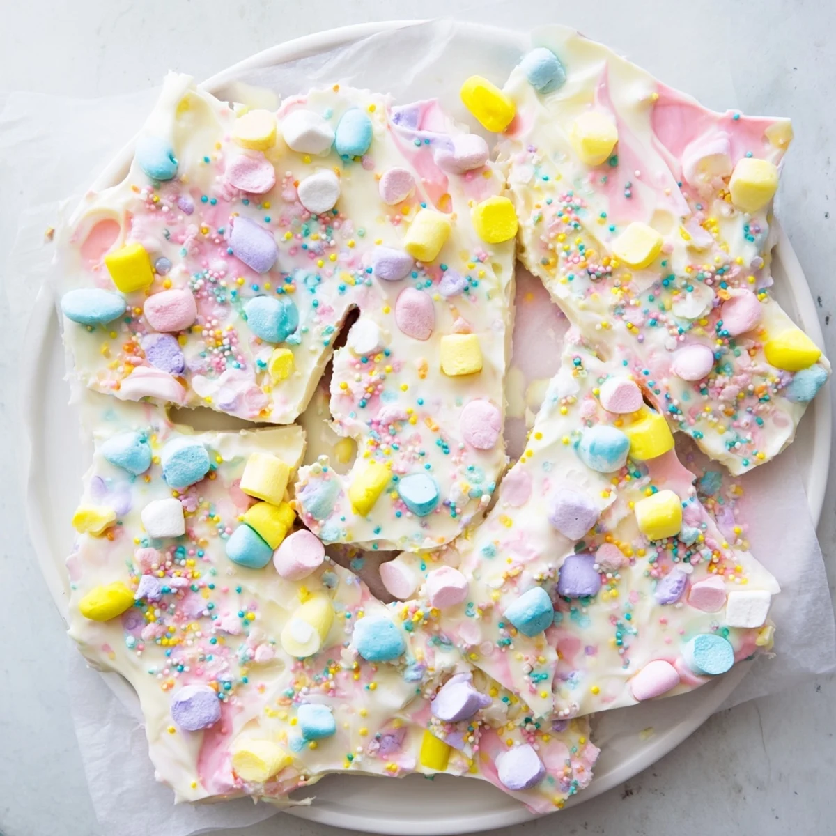 Homemade Easter marshmallow bark featuring mini marshmallows and candy-coated chocolate eggs ready for holiday celebrations