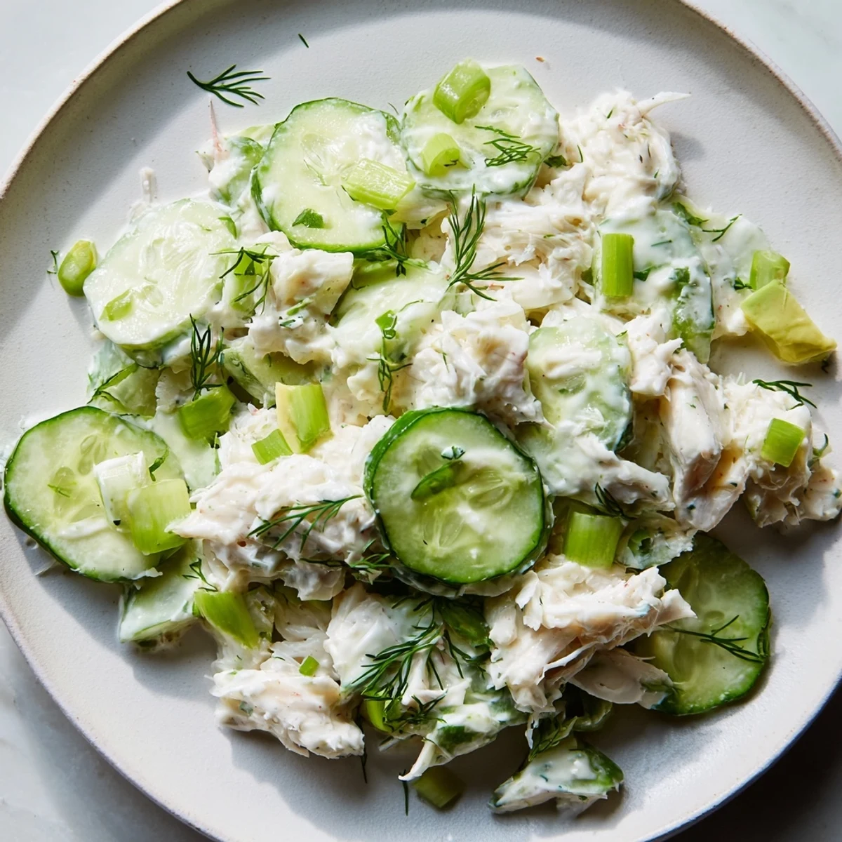 Chilled cucumber salad with crab meat featuring crisp slices and tender sweet seafood