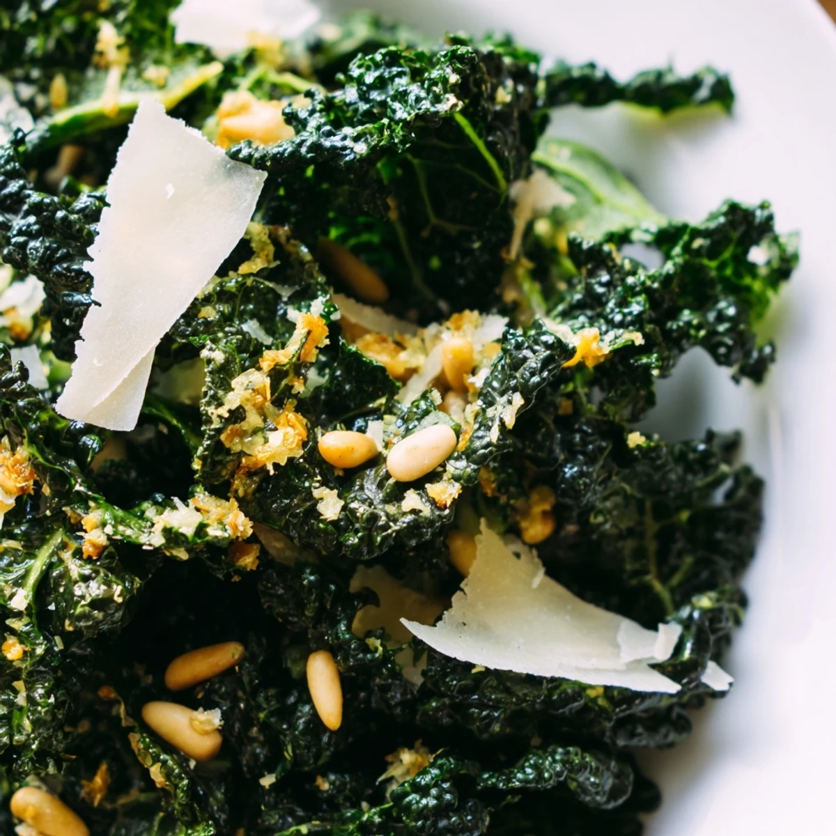 Curly kale tossed in zesty lemon garlic Parmesan dressing topped with shaved cheese and pine nuts