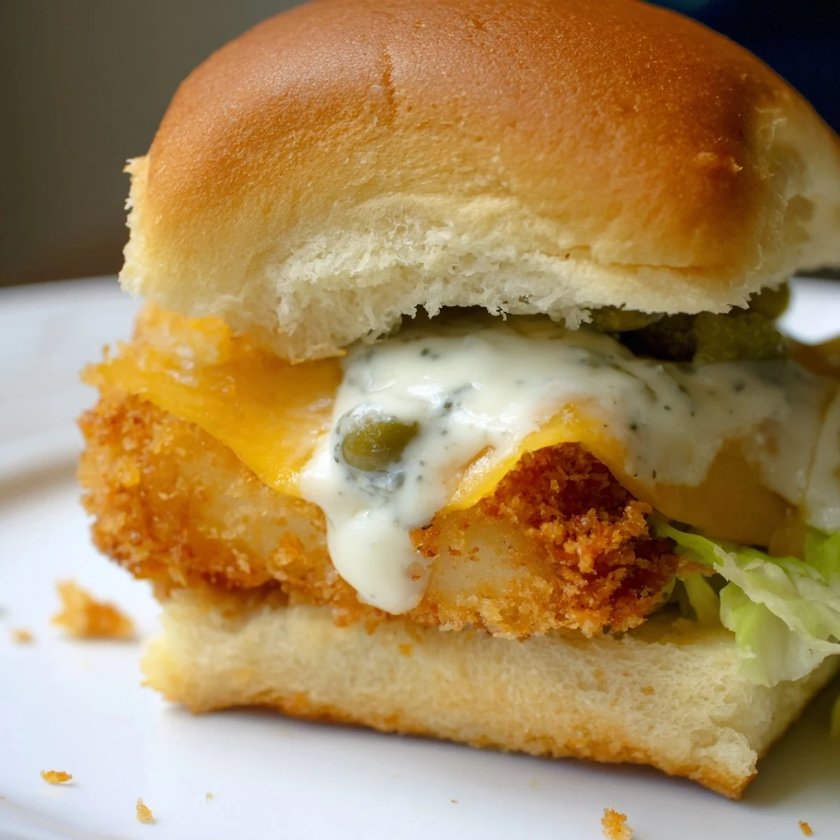 Mini Filet O Fish sliders topped with crunchy lettuce and tangy homemade tartar sauce