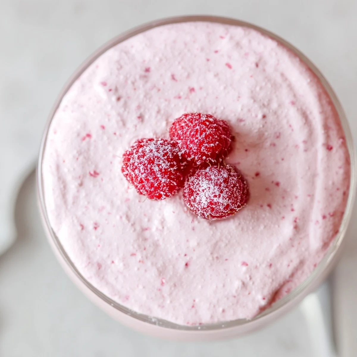 Silky pink Raspberry Cloud Mousse with airy whipped texture in clear dessert glasses