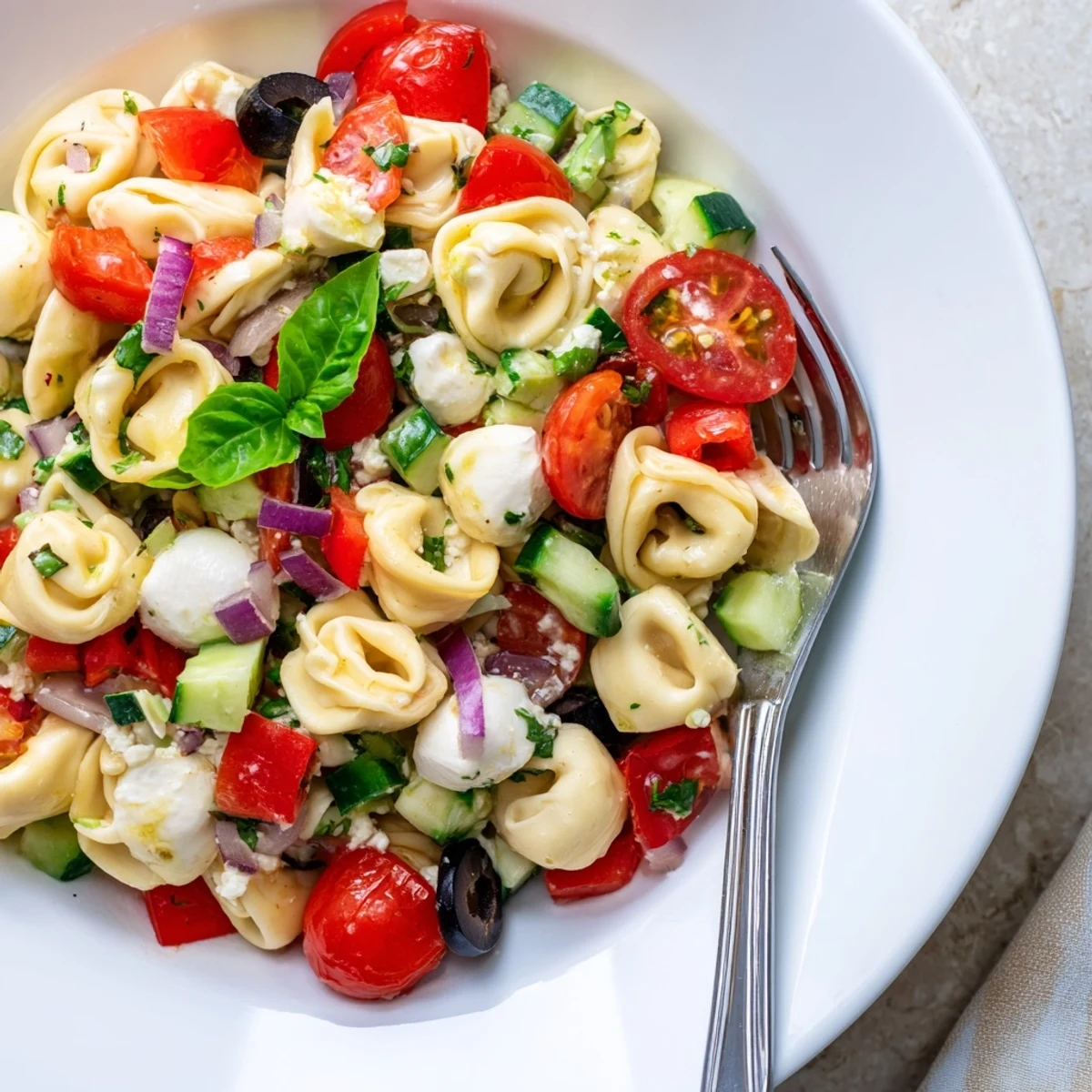 Creamy cheese tortellini pasta salad tossed with bell peppers and Italian dressing
