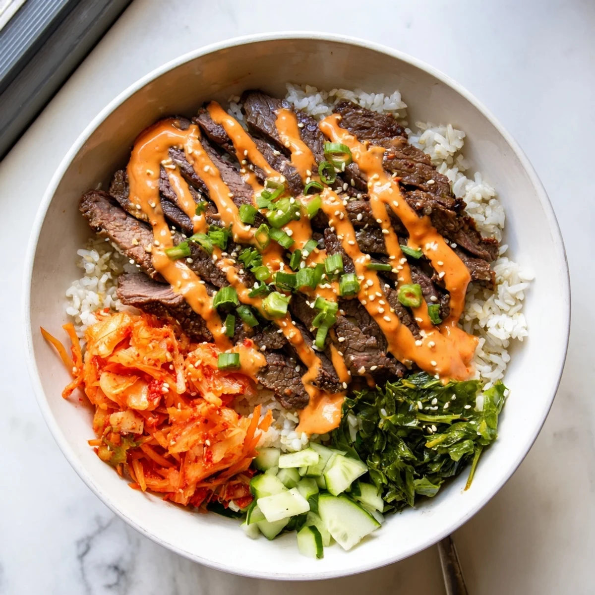 Sizzling Korean BBQ steak rice bowls drizzled with spicy cream sauce over fluffy jasmine rice.