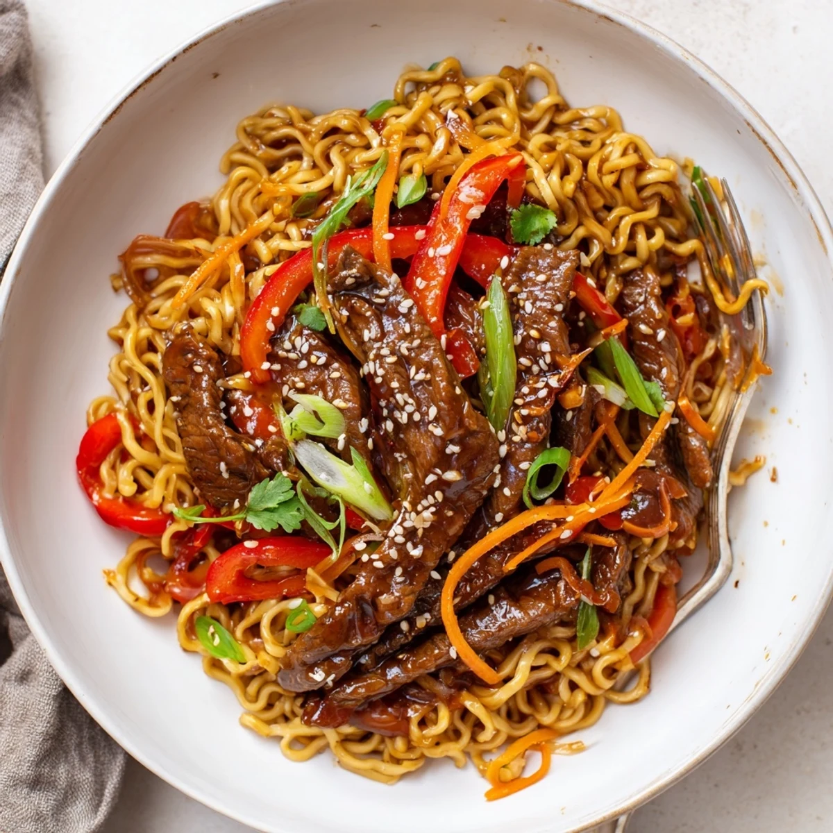 Sticky Beef Noodles glistening in glossy sauce, sesame garnish, steam rising