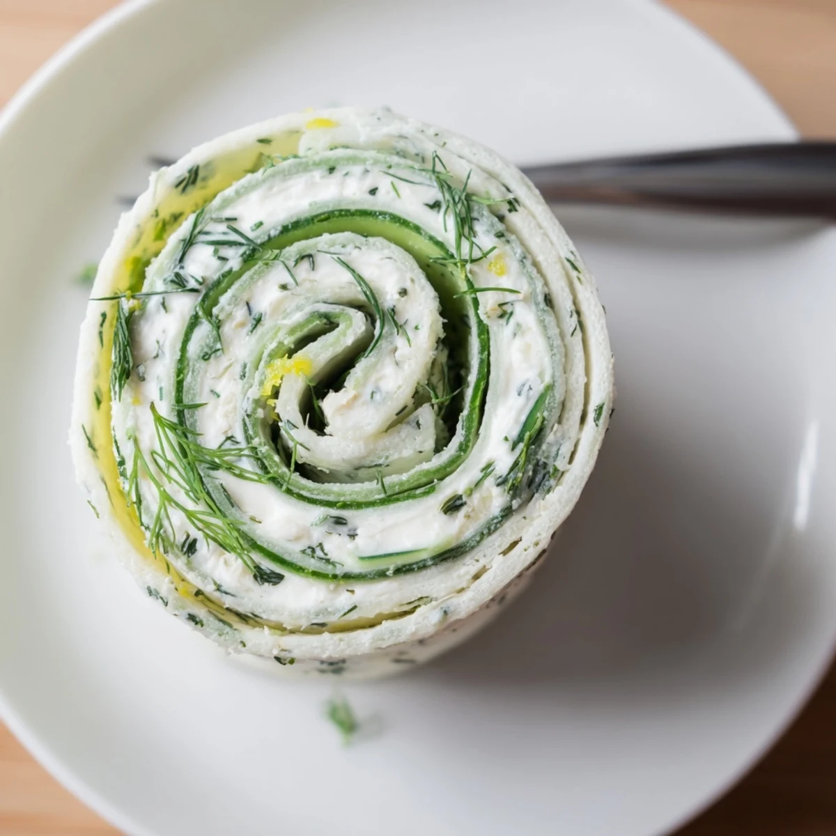 Chilled Cucumber And Dill Pinwheels sliced into spirals, perfect for parties.