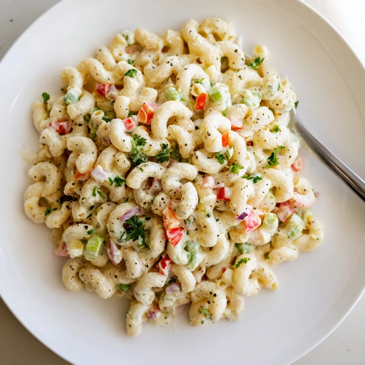 Creamy Macaroni Salad with crisp celery and bell pepper, chilled picnic side.