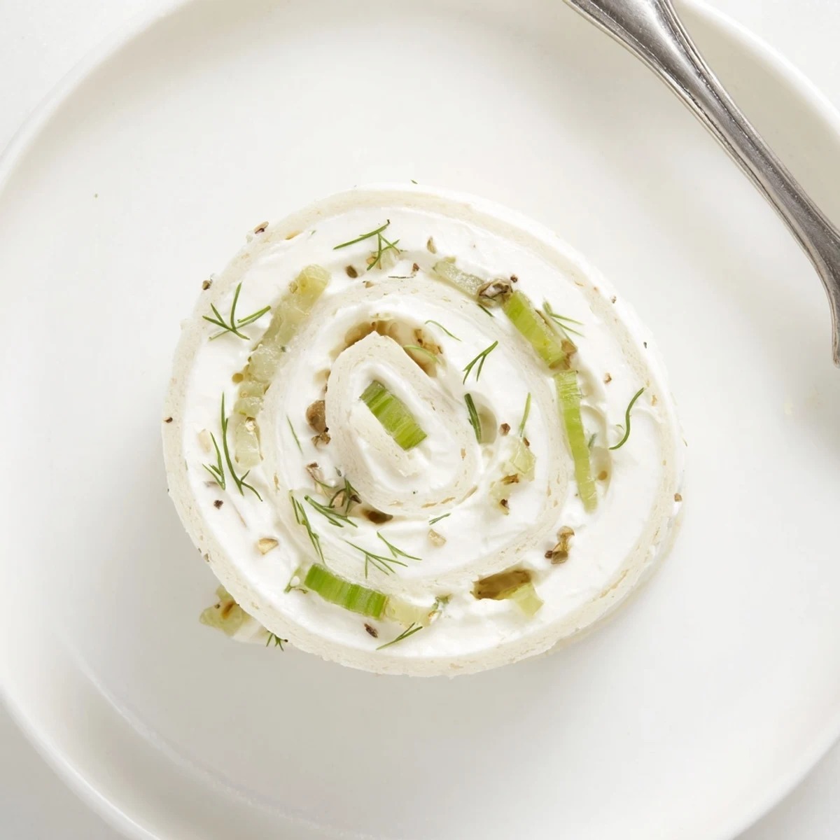 Creamy Pickle Dip Pinwheels rolled in flour tortillas, garnished with green onions