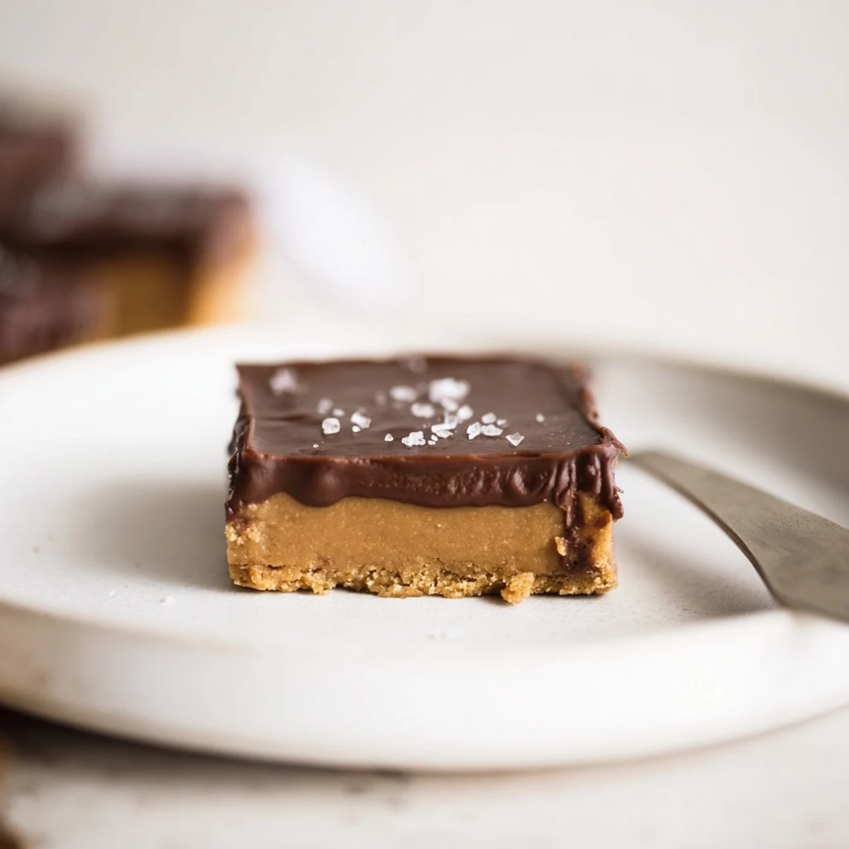 Sliced No Bake Peanut Butter Bars on plate, creamy center, crunchy graham base.