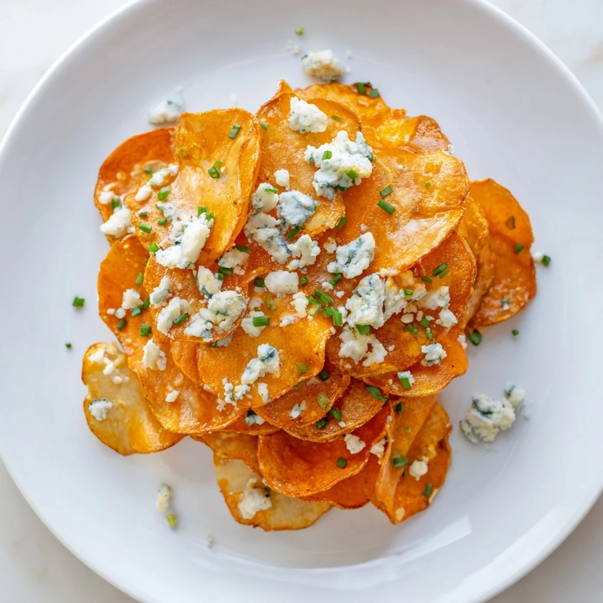 Golden crispy Buffalo chips drizzled with spicy red sauce and topped with blue cheese crumbles