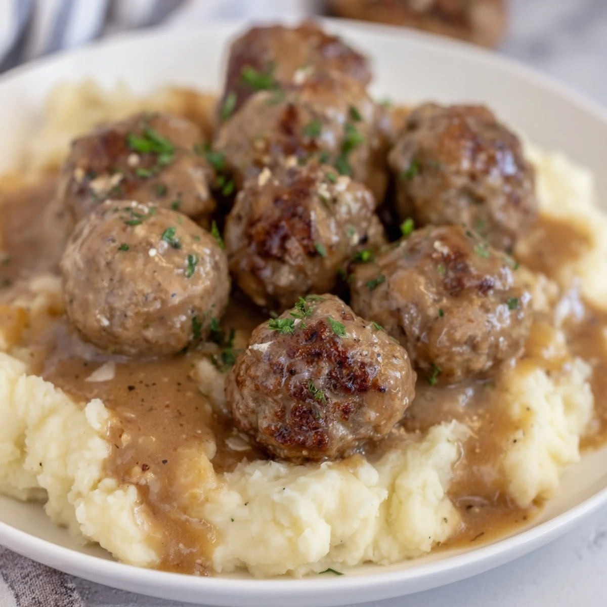 Hearty Crockpot Meatballs Gravy with flecks of parsley, tender beef meatballs visible