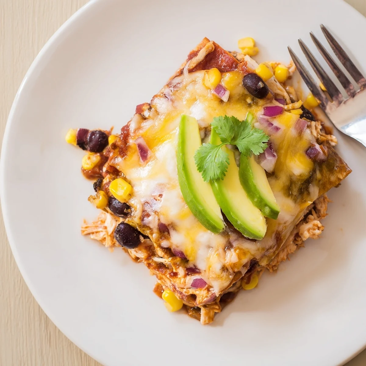 Steaming Salsa Verde Chicken Casserole with melted cheese, cilantro, lime wedges