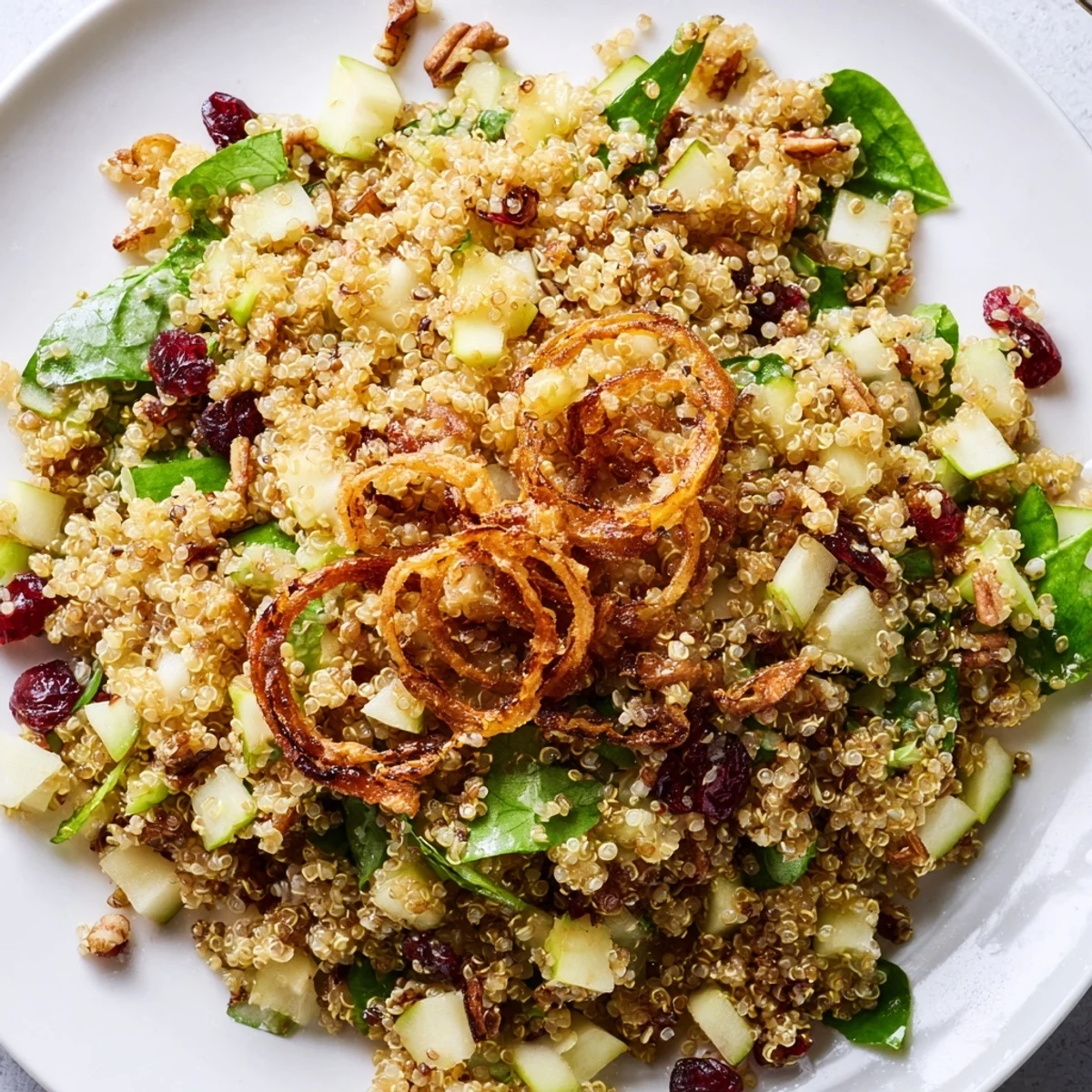 Colorful honey mustard quinoa apple salad with diced Honeycrisp apples, cranberries, and a tangy dressing
