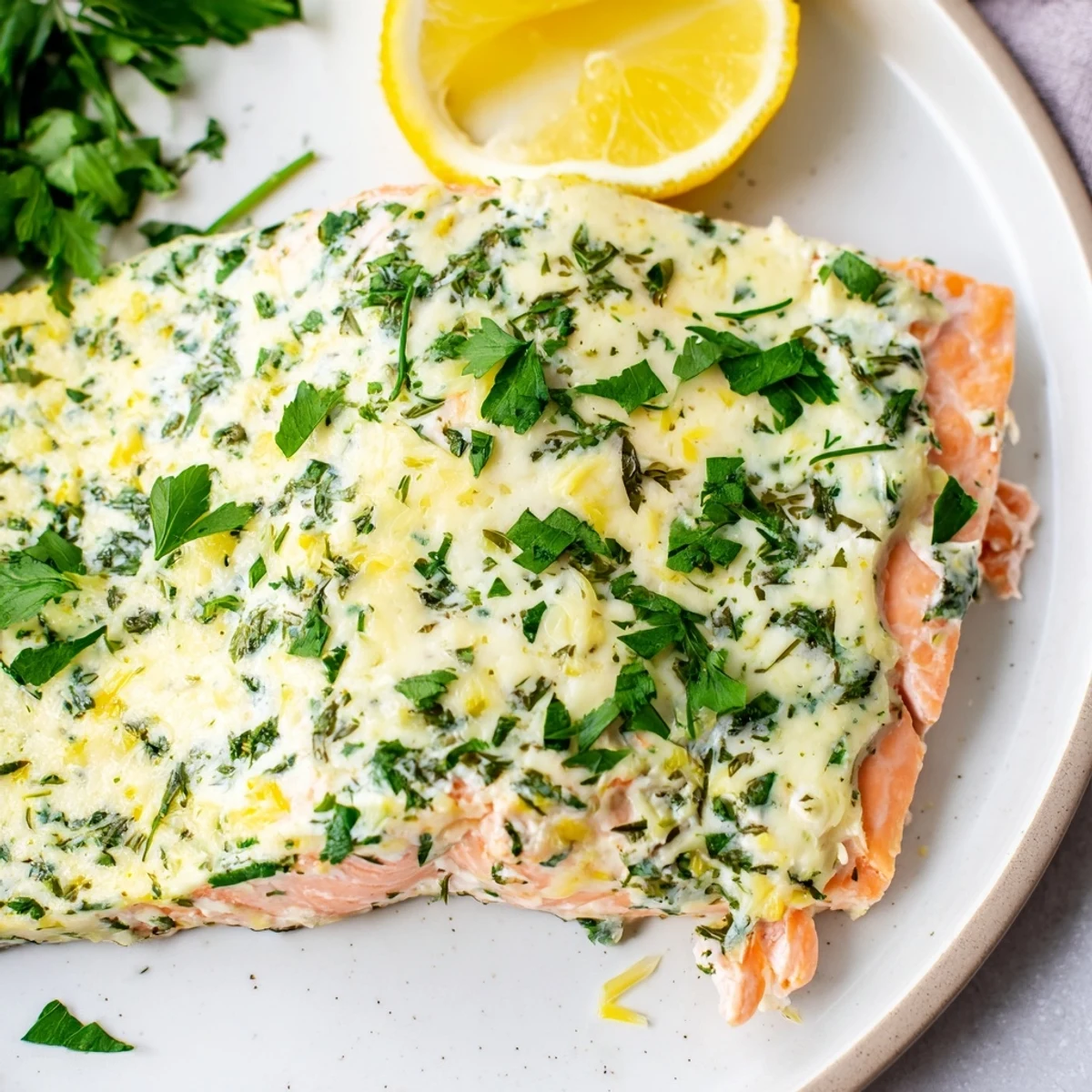 Tender baked Boursin salmon glistening with melted cheese, fresh parsley, and citrus garnish