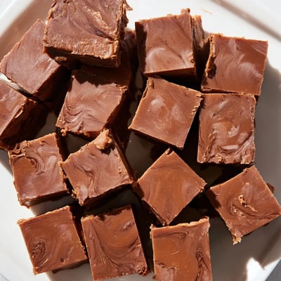 Perfect for St. Patrick's Day, this homemade Irish Cream Fudge showcases a smooth, fudgy texture and rich cocoa flavor in every bite.
