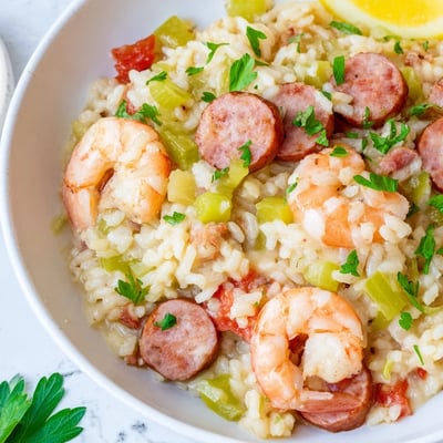 Creole Jambalaya Risotto features creamy Arborio rice with shrimp, sausage, and diced vegetables, garnished with fresh parsley.