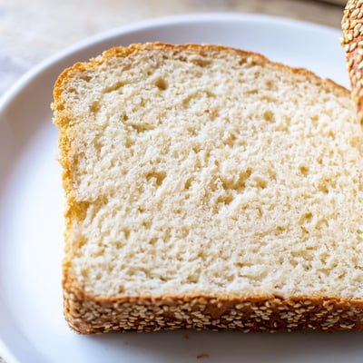 Fluffy keto zero carb yogurt bread toasted with melted butter on a plate