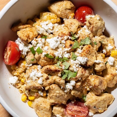 Golden grilled chicken tossed with charred corn and juicy tomatoes in this high protein chicken street corn salad.