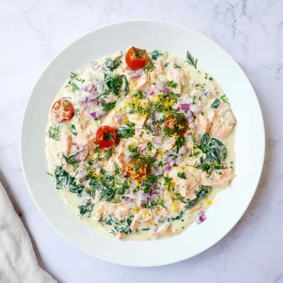 Bowl of healthy leftover salmon recipe served over brown rice with fresh parsley garnish.